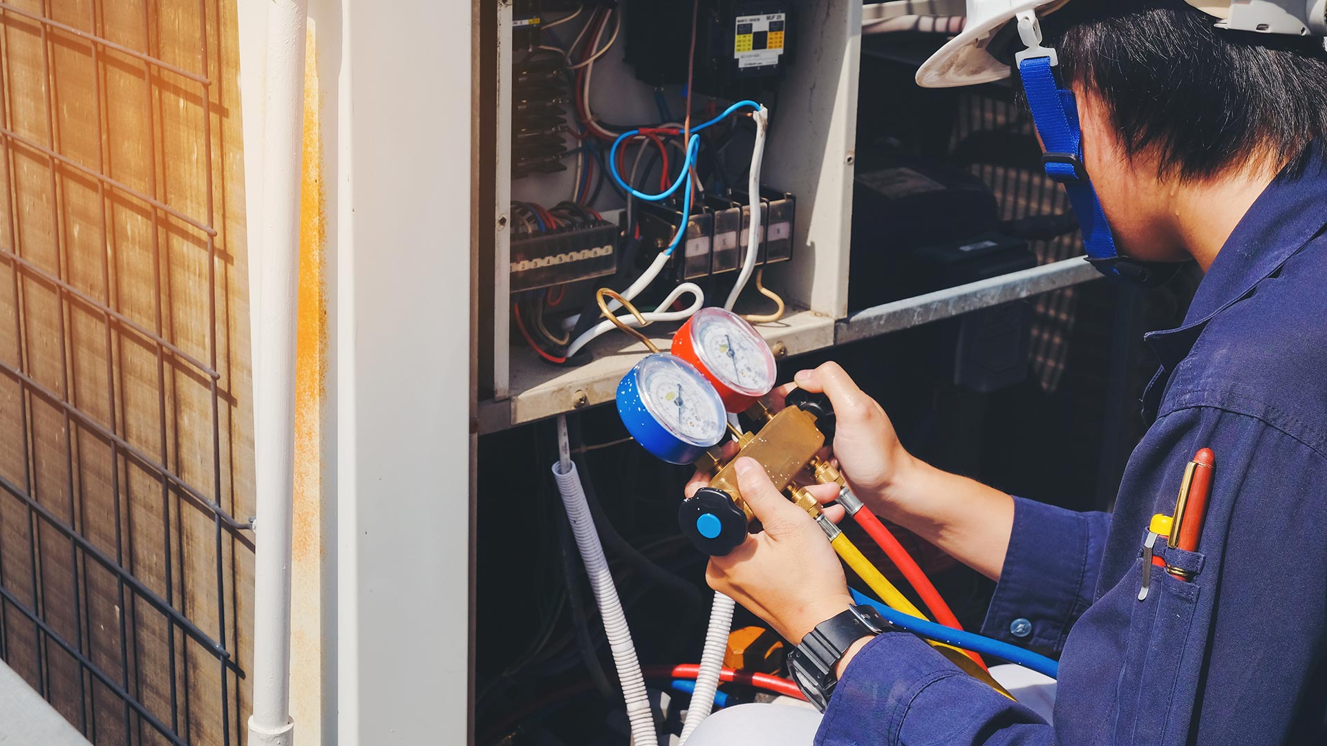 hvac technician repairing hvac unit