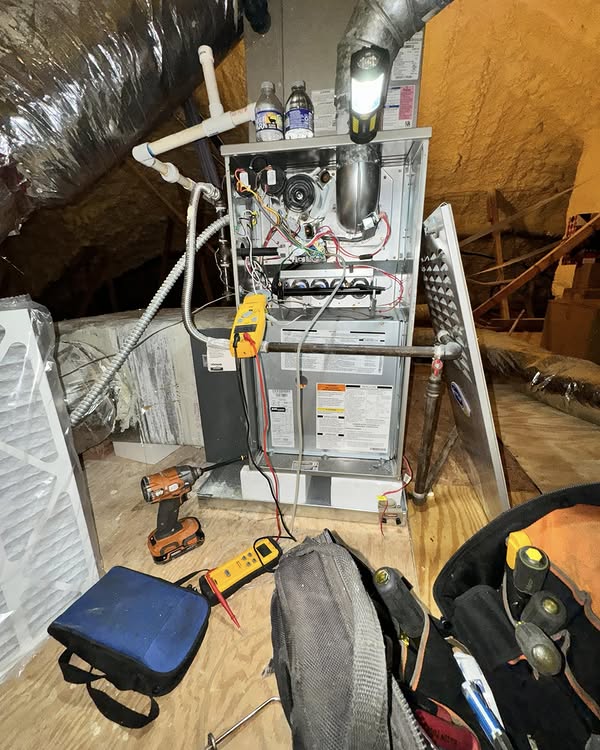 Heater repair service in an attic, featuring HVAC unit with tools and equipment, emphasizing B Mays Heating & Air Conditioning's commitment to reliable HVAC solutions.