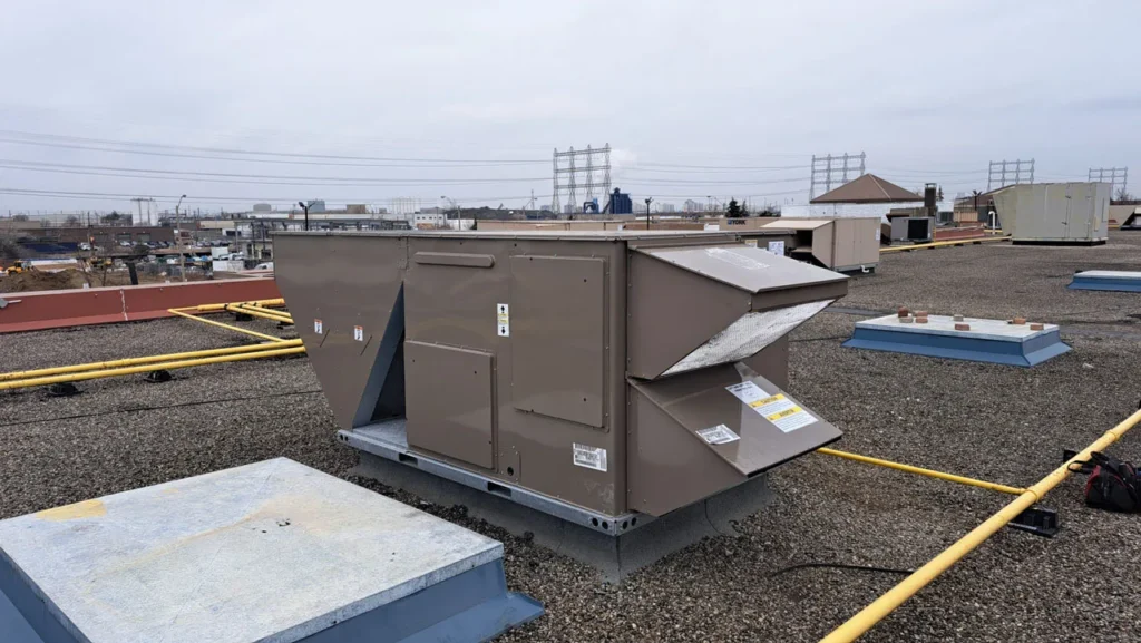 Commercial rooftop HVAC unit on a gravel rooftop, showcasing service capabilities for businesses in Lawrenceville, GA, emphasizing reliable heating and cooling solutions.